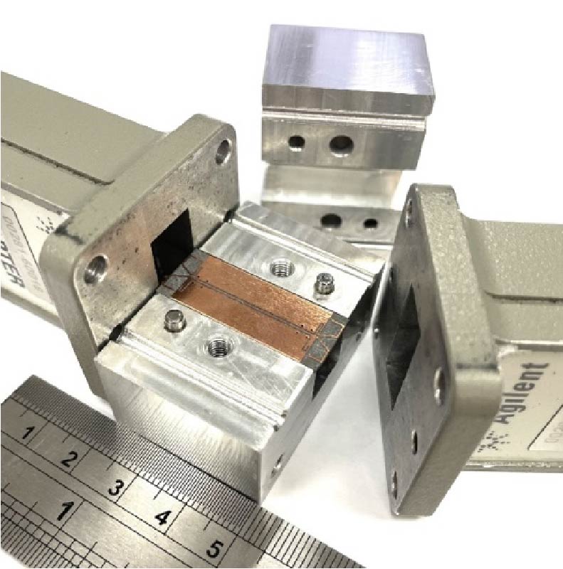 Miniaturized Coplanar Waveguide to Rectangular Waveguide Transition Using Integrated Resonators and Variable Housing